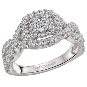 This is a split shank diamond ring created in 14k white gold with a double halo of sparkling diamonds that surrounds the center stone.