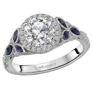 This beautiful 14kt white gold semi-mount ring has diamond and sapphires along the shaft and a halo of diamonds surrounding a setting that will accommodate a 6.5mm round diamond. (D 1/5 carat total weight, S 3/8 carat total weight)