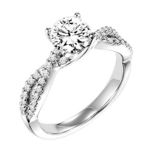 Frederick Goldman This engagement ring features a diamond prong set band with a delicate twist design elegantly leading up to the round center diamond for an alluring look. Center stone not included.
