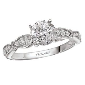 Diamond engagement ring set in 18kt white gold with milgrain detail and a 14K peg head center. (D.1/5 carat total weight) This item is a SEMI-MOUNT and it comes with NO CENTER STONE as shown but it will accommodate a 6.5mm round center stone. Peg Head