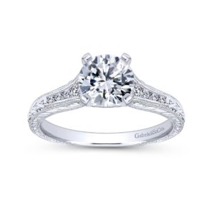Hand cut etching and diamond filled channels decorate Gabriel & Co.'s exquisite band to create this vintage engagement ring. Center stone not included.