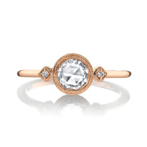 A half carat rose-cut diamond rests in a golden bezel, accented by brilliant white diamonds and finished with fine milgrain detailing in this charming design from the Lumiere Bridal Collection.