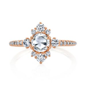 A half carat rose-cut diamond glows in a halo of sprinkled brilliant white diamonds atop gleaming high polished gold in this feminine and stunning design from the Lumiere Bridal Collection.