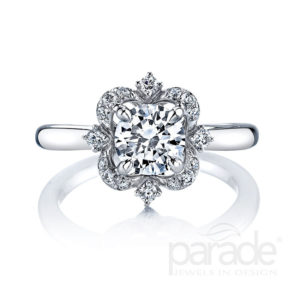 A brilliant center diamond sparkles within an artistic diamond halo, sitting atop a gleaming band of 18K gold.